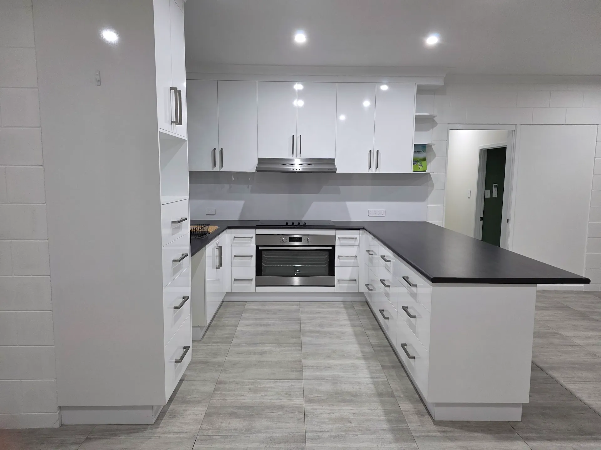 Empty kitchen with cleared benchtops and cabinets ready for a Townsville bond clean inspection