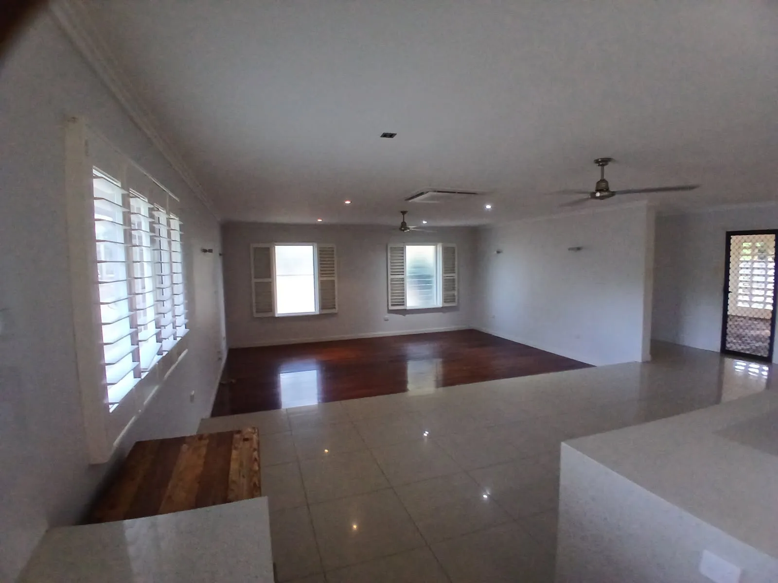 Open-plan living area with polished timber and tile floors
