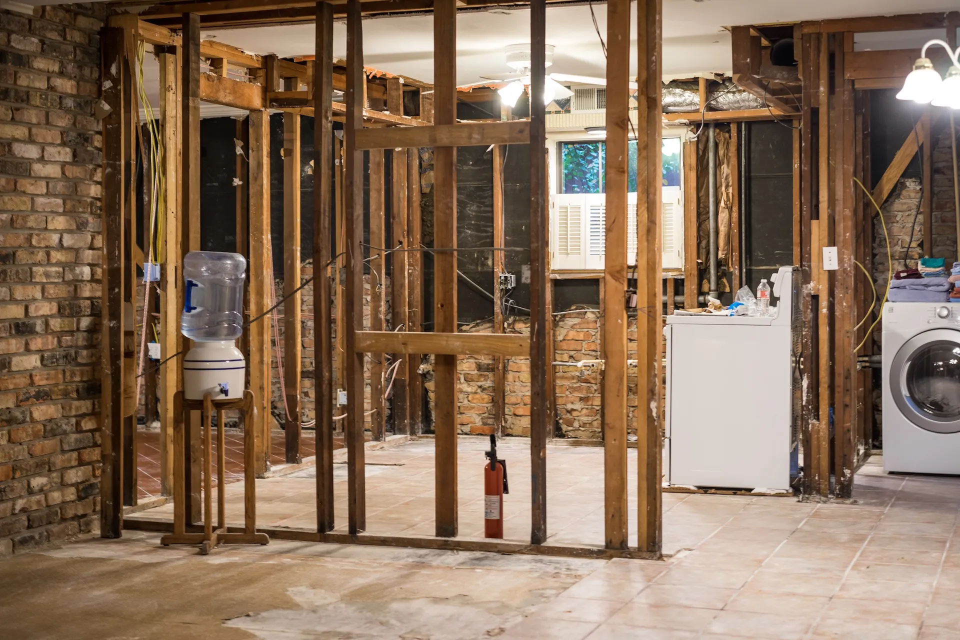 Stripped-back interior of a Townsville property with exposed timber wall framing ready for a builders clean